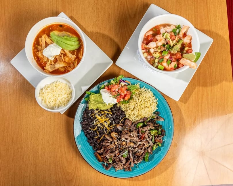 Three Mexican dishes: tortilla soup, shrimp ceviche, and a fajita plate with rice and beans.